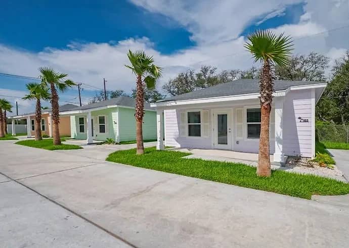 Salty Breeze Cottage, a white cottage with palm trees