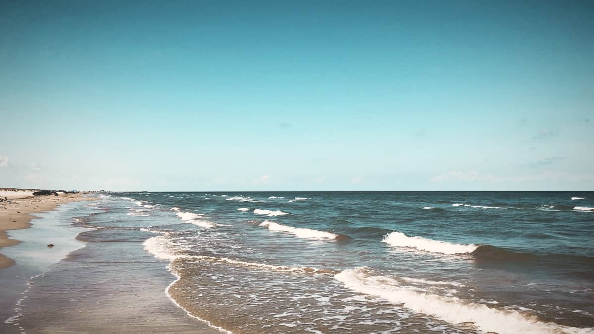Surf rolling onto an empty Gulf beach at Mustang Island State Park